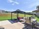 Outdoor patio space with grill, seating, and gazebo overlooking the backyard at 138 Brookhaven Dr, Villa Rica, GA 30180