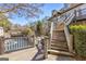 Multi-level deck overlooking peaceful lake with stairs leading up to the main house at 504 Mill Pond Se Ct, Smyrna, GA 30082