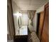 Cozy bathroom featuring a vanity with oval mirror, patterned curtain, and wooden cabinet at 1761 Hosea L Williams Dr, Atlanta, GA 30317