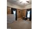 Bedroom featuring wood walls, carpet flooring, and dark curtains at 1761 Hosea L Williams Dr, Atlanta, GA 30317