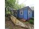 Charming home featuring a blue exterior, front porch, and a convenient access ramp at 1761 Hosea L Williams Dr, Atlanta, GA 30317