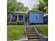 Charming blue home with a welcoming front porch and well-maintained lawn at 1761 Hosea L Williams Dr, Atlanta, GA 30317