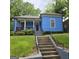 Charming home featuring a blue exterior, front porch and stairway entrance at 1761 Hosea L Williams Dr, Atlanta, GA 30317