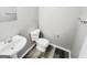 Cozy half-bathroom featuring a toilet, sink, and modern fixtures for a functional and stylish space at 1464 Riverrock Trl, Riverdale, GA 30296