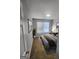 Comfortable bedroom featuring a queen-size bed, neutral decor, and a window providing ample natural light at 1464 Riverrock Trl, Riverdale, GA 30296