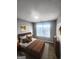 Well-lit bedroom featuring a comfortable bed, coordinated decor, and ample natural light from the window at 1464 Riverrock Trl, Riverdale, GA 30296