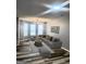 Bright living room featuring a large sectional sofa, modern lighting, and stylish decor at 1464 Riverrock Trl, Riverdale, GA 30296