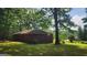 Lush backyard with mature trees offers a serene outdoor setting around this brick home at 305 Flat Shoals Church Rd, Stockbridge, GA 30281