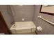 This bathroom features a tub and shower combo, tile floors, and updated fixtures at 305 Flat Shoals Church Rd, Stockbridge, GA 30281