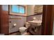 Compact bathroom with blue and purple tile, toilet, sink, and window for natural light at 305 Flat Shoals Church Rd, Stockbridge, GA 30281