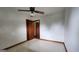 This bedroom includes tile flooring, a ceiling fan, and trim throughout at 305 Flat Shoals Church Rd, Stockbridge, GA 30281
