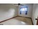 Simple bedroom features tile flooring, a ceiling fan, a window, and trim around the room at 305 Flat Shoals Church Rd, Stockbridge, GA 30281