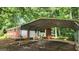 Covered carport attached to a charming brick and white home, providing shelter for vehicles at 305 Flat Shoals Church Rd, Stockbridge, GA 30281