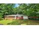 Charming brick ranch-style home with a car port nestled among mature trees in a serene setting at 305 Flat Shoals Church Rd, Stockbridge, GA 30281