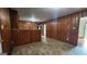 Open kitchen and dining area featuring wood paneling and tile flooring at 305 Flat Shoals Church Rd, Stockbridge, GA 30281