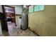 Utility room features a washer, dryer, and water heater with easy access to kitchen at 305 Flat Shoals Church Rd, Stockbridge, GA 30281