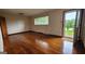 Bright living room with hardwood floors, a large window, and an open doorway at 305 Flat Shoals Church Rd, Stockbridge, GA 30281