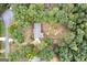 An aerial view of the home and surrounding landscape showing the roof, driveway, and mature trees at 126 Country Acres Ct, Mcdonough, GA 30253