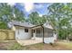 A view of the rear of a white brick home with an outdoor patio and fenced yard at 126 Country Acres Ct, Mcdonough, GA 30253