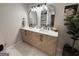 Bright bathroom featuring a double vanity, modern fixtures, and a cabinet with natural wood finish at 126 Country Acres Ct, Mcdonough, GA 30253