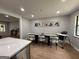 Cozy dining area featuring a long table, comfortable seating, and natural light from nearby window at 126 Country Acres Ct, Mcdonough, GA 30253
