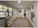 Neutral hallway featuring a black-framed window, artwork, and access to a screened-in porch at 126 Country Acres Ct, Mcdonough, GA 30253