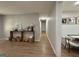 Open-concept hallway with wood floors, neutral paint, and decoratively appointed console table at 126 Country Acres Ct, Mcdonough, GA 30253