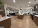 Bright kitchen with stainless steel appliances, wooden cabinets, an island, and an open floor plan at 126 Country Acres Ct, Mcdonough, GA 30253