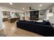 Spacious living room with a brick fireplace, fan, and open access to the kitchen at 126 Country Acres Ct, Mcdonough, GA 30253
