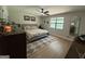 A modern bedroom featuring hardwood floors, a ceiling fan, and a large window at 126 Country Acres Ct, Mcdonough, GA 30253
