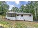 Back of a charming white brick house with a screened in porch at 126 Country Acres Ct, Mcdonough, GA 30253