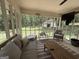 Relaxing sunroom with ample seating and views of the wooded backyard at 126 Country Acres Ct, Mcdonough, GA 30253