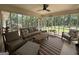 Relaxing sunroom with ample seating and views of the wooded backyard at 126 Country Acres Ct, Mcdonough, GA 30253