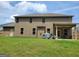 Spacious backyard with a covered patio area, perfect for outdoor dining and relaxation, with ample green space at 436 Lothbury Ave, Locust Grove, GA 30248