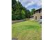 Large backyard with a wooden fence, offering privacy and space for outdoor activities and entertaining at 436 Lothbury Ave, Locust Grove, GA 30248