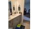 Bathroom vanity with light grey cabinets, white countertop, and brushed bronze hardware at 436 Lothbury Ave, Locust Grove, GA 30248