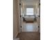 This bathroom features a large soaking tub, tile floors, and white double doors at 436 Lothbury Ave, Locust Grove, GA 30248