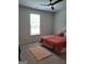 Cozy bedroom with a soft rug, plush bedding, and a sunlit window at 436 Lothbury Ave, Locust Grove, GA 30248