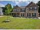 Charming two-story home featuring brick accents, a well-manicured lawn, and a welcoming covered front porch at 436 Lothbury Ave, Locust Grove, GA 30248