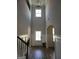 Spacious foyer with soaring ceilings, decorative lighting, hardwood floors, and elegant trim work at 436 Lothbury Ave, Locust Grove, GA 30248