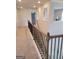 Upstairs hallway with carpet, natural light, and decorative railing at 436 Lothbury Ave, Locust Grove, GA 30248