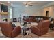 Inviting living room with leather seating, a fireplace, and modern ceiling fan at 436 Lothbury Ave, Locust Grove, GA 30248