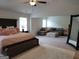 Spacious main bedroom with a seating area, neutral walls and carpeted floor at 436 Lothbury Ave, Locust Grove, GA 30248