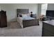 Cozy main bedroom with plush carpeting, a neutral color scheme, and a large window for natural light at 436 Lothbury Ave, Locust Grove, GA 30248