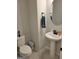 Bright powder room with pedestal sink, round mirror, and white toilet at 436 Lothbury Ave, Locust Grove, GA 30248