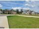 Street view showcasing a community of well-maintained homes with green lawns and mature trees at 436 Lothbury Ave, Locust Grove, GA 30248