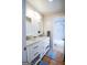 The bathroom has a double vanity with a marble countertop, and a door to the shower and tub at 577 Rivers Rd, Fayetteville, GA 30214