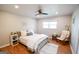 This bedroom offers a cozy reading chair, wood flooring, and a ceiling fan at 577 Rivers Rd, Fayetteville, GA 30214