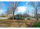 Charming home with a welcoming front porch and mature trees in a landscaped yard at 577 Rivers Rd, Fayetteville, GA 30214