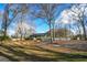 Well-maintained home with a spacious yard, mature trees, and a charming front porch at 577 Rivers Rd, Fayetteville, GA 30214